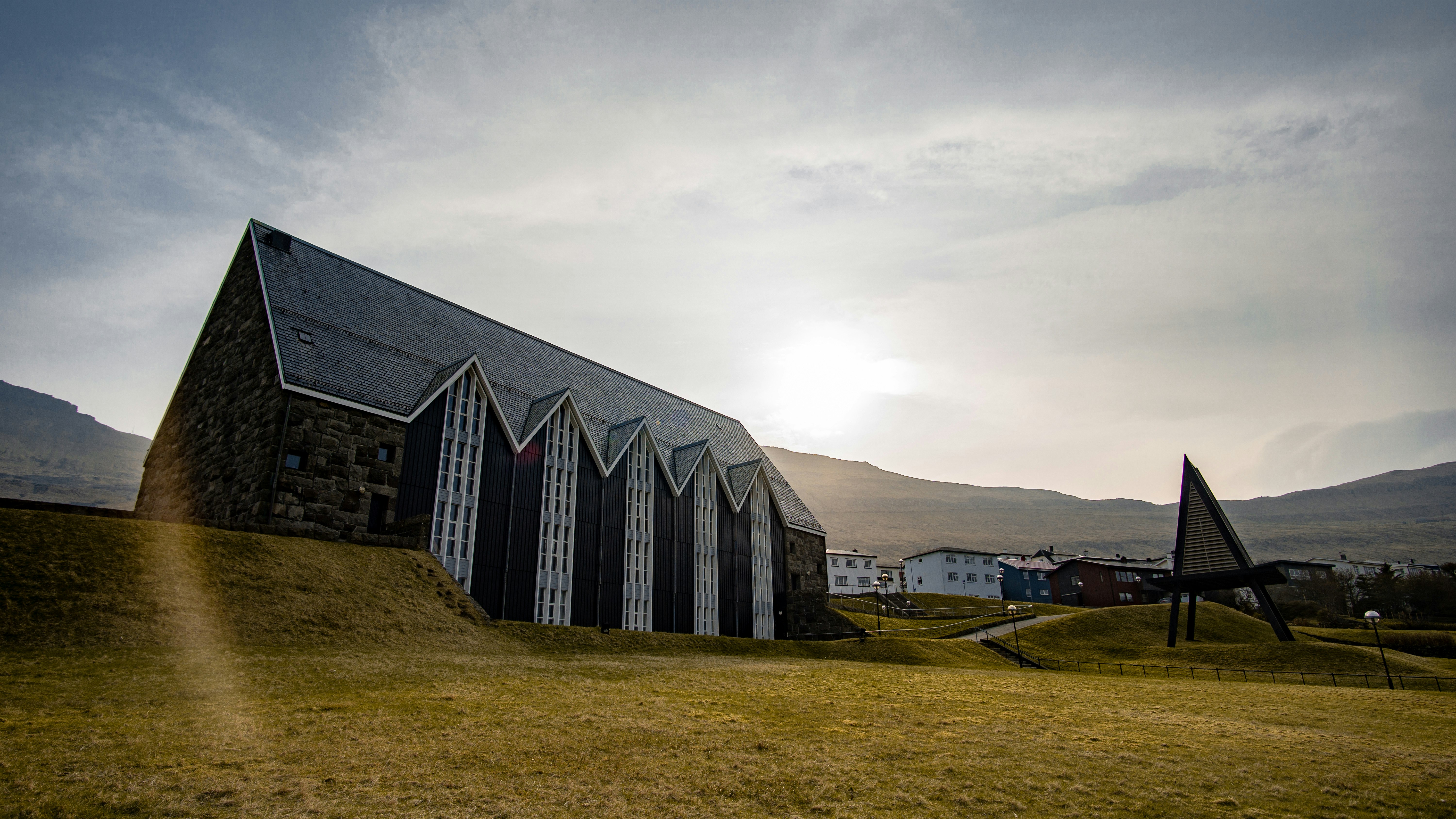 brown and black concrete building on grass field